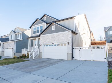 Craftsman-style house featuring a gate, concrete driveway, an attached garage, and stone siding