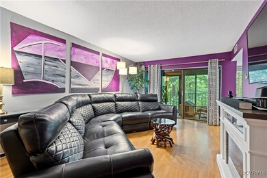 Living room with light wood-type flooring and a te