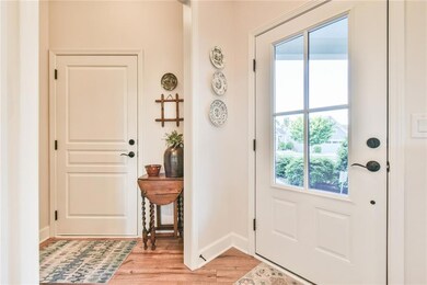 Entryway with baseboards and light wood-style floo