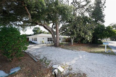 Front of home with shell driveway