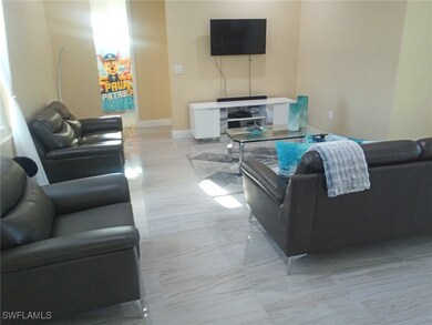 Living area with baseboards and marble finish floo