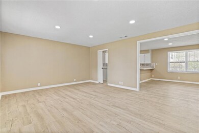 Unfurnished living room featuring visible vents, b