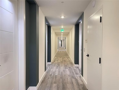Hall with wood finished floors and baseboards