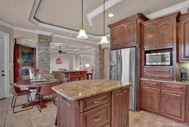 Kitchen featuring brick wall, a kitchen island, ce