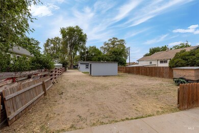 Fenced backyard with an outbuilding