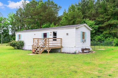 Rear view of house featuring a wooden deck