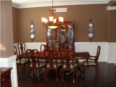 Large Formal Dining Area has a solid wood floor