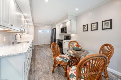 Dining space featuring dark wood-type flooring, recessed lighting, and crown molding