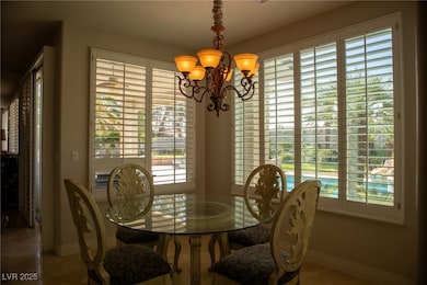Dining room featuring a chandelier, baseboards, an