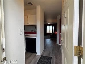 Hallway featuring light wood-style flooring and vi