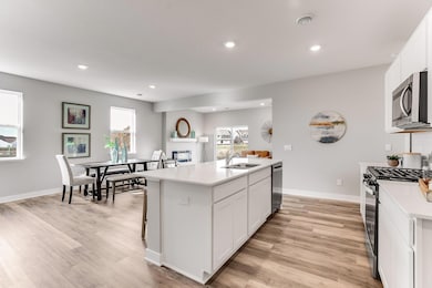 This open concept main level allows for ease in entertaining.  Wonderful accessibility to the dining room and living room.  *Photo is of a model home.