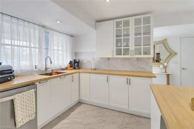 Kitchen with light tile patterned flooring, white 