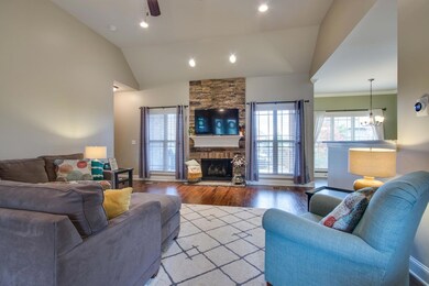 The comfortable and spacious living room with true wood flooring and fireplace is at the center of the first floor. 