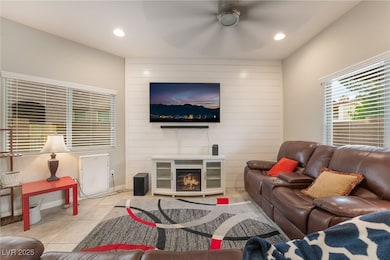 Living area featuring tile patterned floors, reces