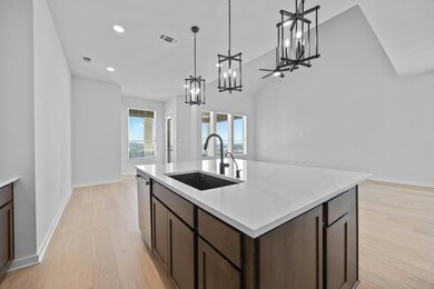Kitchen with a chandelier, stainless steel dishwa