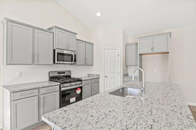 Kitchen featuring light wood-type flooring, stainl