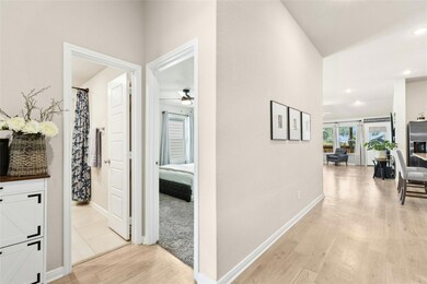Hallway with light wood finished floors and recessed lighting