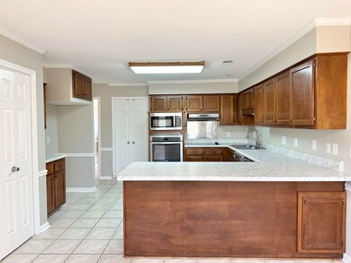Kitchen with light countertops, a sink, appliances