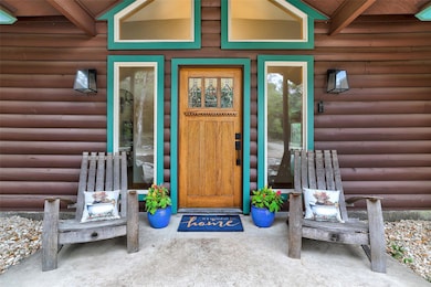 Entrance to property with faux log siding