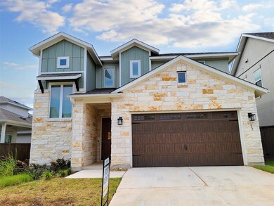 Contemporary home featuring stone siding, drivewa