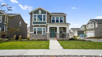 Craftsman inspired home with stone siding, a front yard, covered porch, and stucco siding