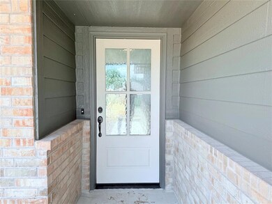 View of exterior entry featuring brick siding