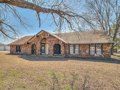 View of front of property with stone siding, a fro