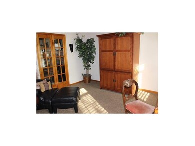 Formal living room. French doors. Carpet.