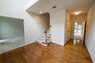2 story foyer opens to living room on left