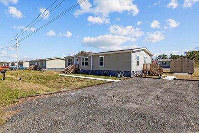 View of front facade with a storage shed, a front 