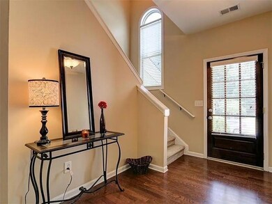 Entryway with wood finished floors, healthy amount of natural light, and stairs