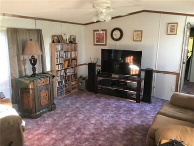 Spacious living room with ceiling fan