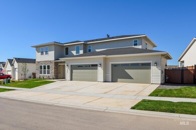 View of front of house featuring driveway, a garage, stone siding, and a shingled roof