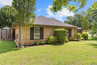 Ranch-style home with a front lawn, brick siding, 