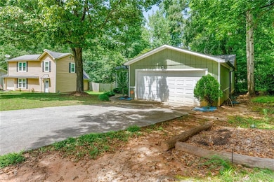 Detached garage with view of scattered trees