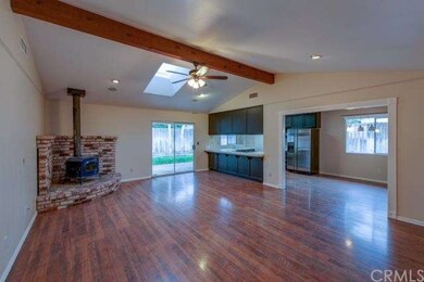 Open living room with cozy wood burning stove and 