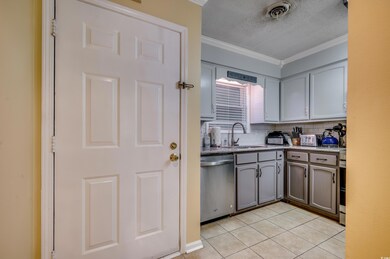 Kitchen featuring dishwasher, sink, decorative bac