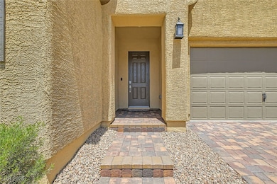 Entrance to property with stucco siding and an att
