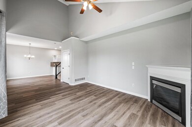 The inviting living room walks into the dining room and kitchen so you can enjoy the fireplace and cozy vibes across the whole main level
