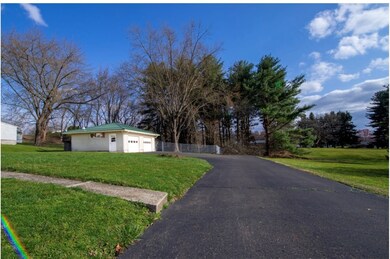 The drive way circles back and has a spacious turn