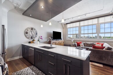 Kitchen with hanging light fixtures, dark hardwood