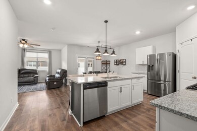 Step into the stunning open kitchen, featuring granite countertops, stainless steel appliances, a walk-in pantry, and an expansive center island – the ideal setting for hosting.