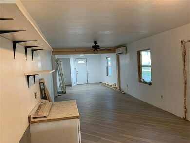 Unfurnished living room featuring hardwood / wood-