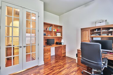 The built in desk area and shelves are a nice feature of the room, along with French Doors.
