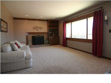 Spacious living room with woodburning fireplace.