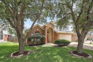 Traditional-style home with brick siding, drivewa