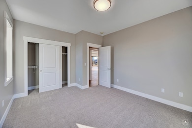 (PHOTO OF SIMILAR HOME) Unfurnished bedroom with light carpet and a closet