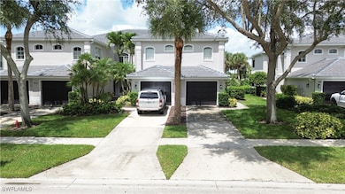 View of front of property with concrete driveway, a garage, stucco siding, and a front lawn