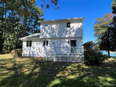 Rear view of property featuring a yard