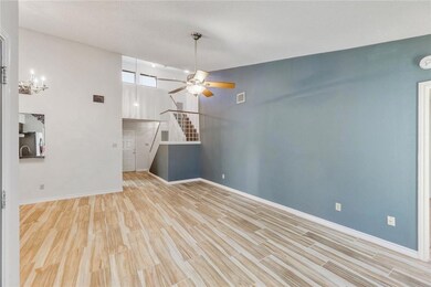 Unfurnished living room featuring a ceiling fan, 